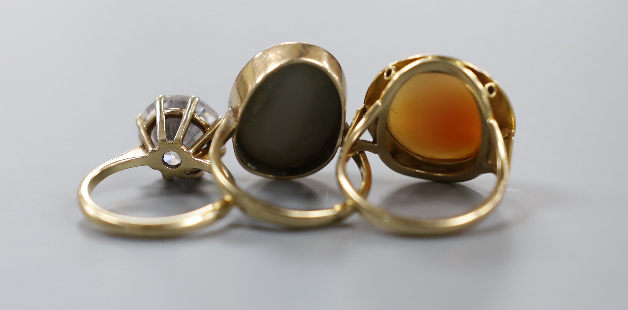 Three assorted modern 9ct dress rings, including cameo and simulated diamond, gross weight 16 grams.